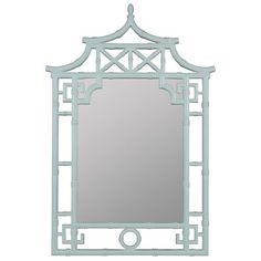 a mirror that is sitting on top of a table with a light blue frame around it