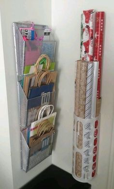 a stack of books and magazines hanging on a wall next to a door with wrapping paper