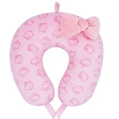 a pink neck pillow with hello kitty print on the front and bow at the top