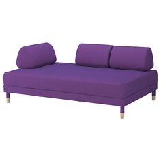 a purple couch sitting on top of a white floor