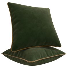 two green velvet pillows with gold piping on the sides and one in dark green