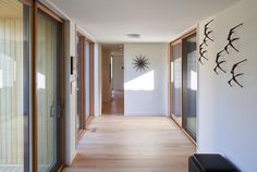 the hallway is clean and ready for guests to use it as an entrance way in this modern home