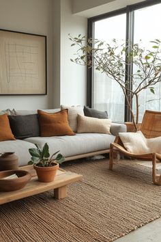 a living room filled with lots of furniture and a tree in the window sill