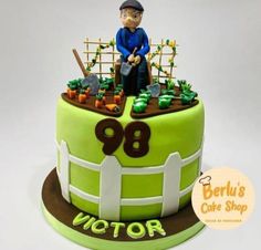 a cake with a man sitting on top of it in the shape of a fence