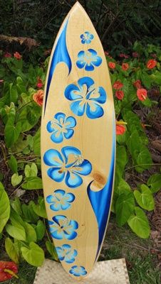 a blue and yellow surfboard sitting in the grass