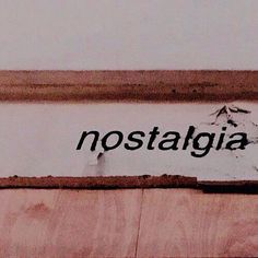 the word nostagia written in black ink on a wall