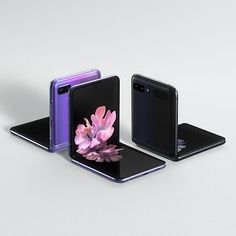 three cell phones with flowers on them are shown in different colors and sizes, one is black the other is purple