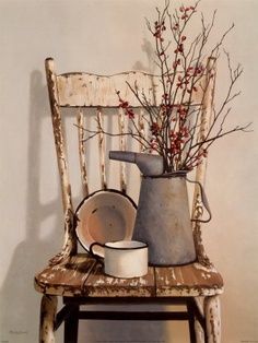 an old chair and vase with flowers in it