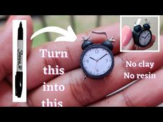 a person holding a small clock in their hand with instructions on how to use it