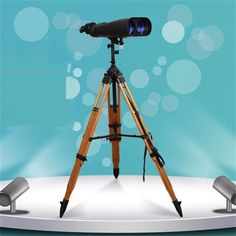 a wooden tripod with a camera on top of it and some speakers behind it