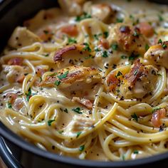 pasta with chicken, shrimp and cheese in a skillet on the stove top ready to be eaten