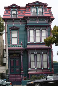 a car parked in front of a multi - colored house