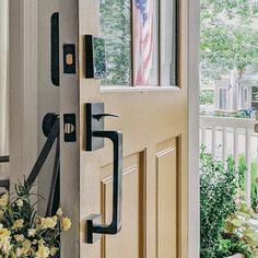 the front door is open and has an american flag hanging on it's side