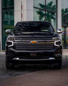 the front end of a black chevrolet suv