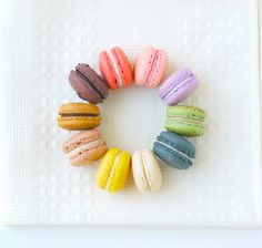 there are many different colored macaroons arranged in a circle