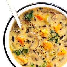 two bowls of soup with mushrooms, carrots and broccoli in it on a white background