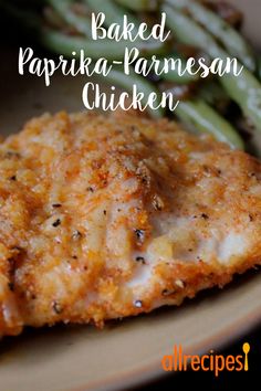 baked paprika - parmesan chicken on a plate with asparagus