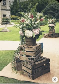 some flowers are in a vase on top of crates