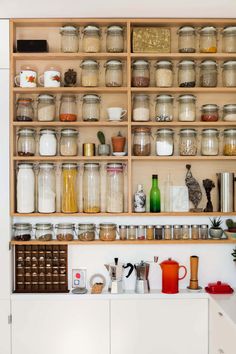 the shelves are filled with many different types of jars