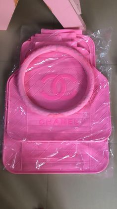 a pink plastic tray with an eye design on the front and bottom, sitting on a table