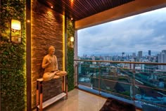 a buddha statue sitting on top of a bench next to a window