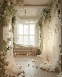 a room with flowers and candles on the floor, in front of a white bed