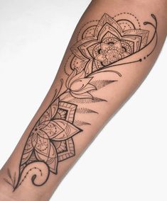 a woman's arm with a tattoo design on the left side of her arm