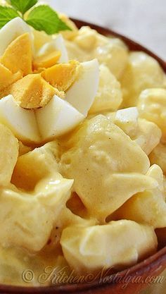 a plate with macaroni and cheese topped with green leafy garnish