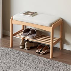 two pairs of shoes are sitting on a wooden shoe rack