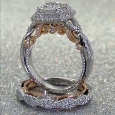 two wedding rings on top of each other with diamonds in the middle and bottom bands