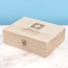 a wooden box sitting on top of a white counter next to a blue wall in the background