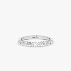 a white gold ring with five diamonds