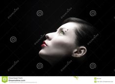 a woman's face with green eyes in the dark stock photo - image 3497