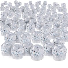 many clear plastic balls are scattered together on a white surface with blue stars in the middle