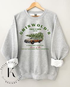 It's All in The Details.... Griswold christmas tree sweater  *NOW AVAILABLE AS A T-SHIRThttps://kaylasimonedesigns.etsy.com/listing/1594171375------ CARE INSTRUCTIONS   **Wash  inside out in cold/warm water with colour safe detergent** **Do not leave wet in washing machine** ---------- ---- if ordering 5+ message me for 10% off --- SIZING :  please refer the the size chart in the listing , if you are unsure I suggest measuring a sweater that fits you and compare to the listed measurements. this Christmas Vacation Sweater, Christmas Vacation Sweaters, Sweater Graphic, Griswold Family Christmas, Griswold Family, National Lampoon, National Lampoons Christmas, Dropped Shoulder Sweatshirt, Graphic Sweaters