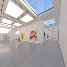 an empty white room with paintings on the wall and skylights above it in daylight