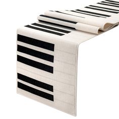 a table runner with black and white piano keys on it