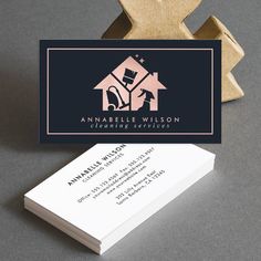 a business card for an interior decorating company, with a house logo on it