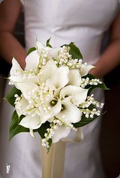 a bridal bouquet with white flowers and baby's breath