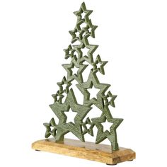 a green metal christmas tree with stars on it's top and bottom, sitting on a wooden stand