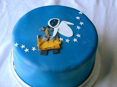 a blue cake with an image of a space shuttle on it's side and stars around the edges