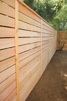 a wooden fence in the middle of a dirt area