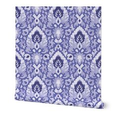 a blue and white wallpaper with an ornate pattern