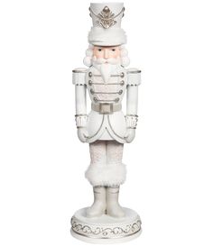 a christmas nutcracker figurine in white with a hat and fur on it's head