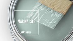 a paint can with a brush in it and the words marina isle painted on it