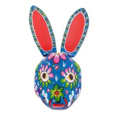 a blue bunny mask with red ears and flowers on it