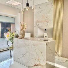 a white marble counter top sitting inside of a building