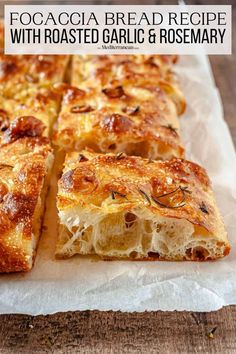 a close up of bread on a piece of paper with text overlay that reads focaccia bread recipe with roasted garlic and rosemary