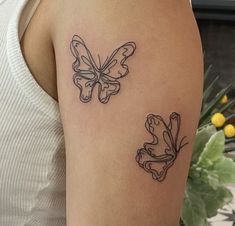 a woman with a butterfly tattoo on her arm