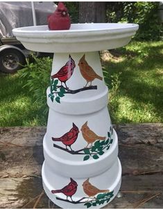 a bird bath sitting on top of a wooden table